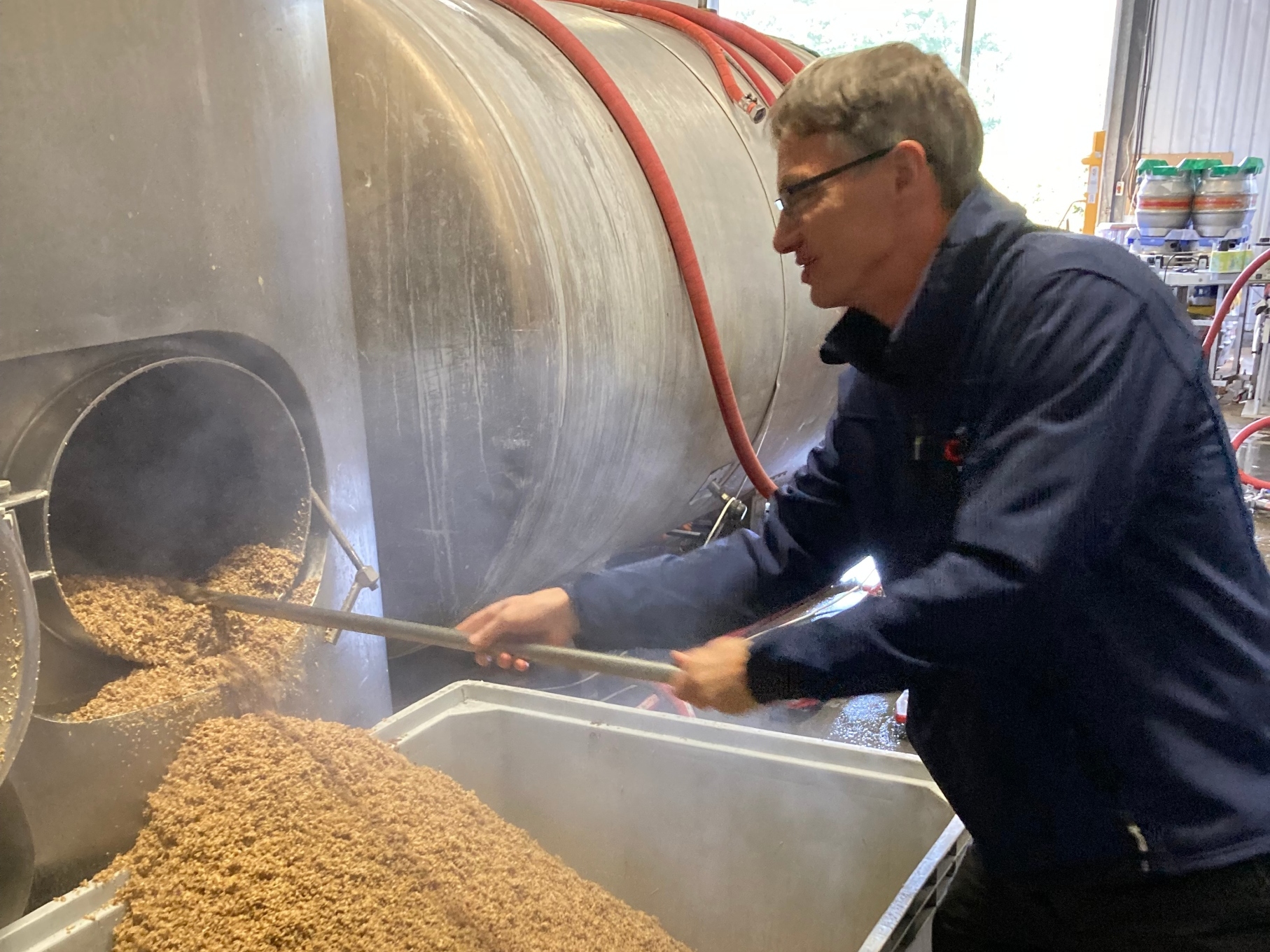 Nigel’s Gibbons from Crisp Malts digs out spent grain at the Time & Tide Brewery